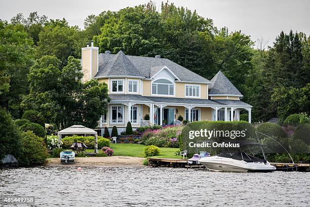 lakefront luxury property on sunny day of summer - waterfront house stock pictures, royalty-free photos & images