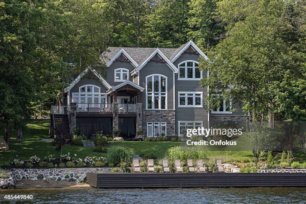 lakefront luxury property on sunny day of summer - cottage water stock pictures, royalty-free photos & images