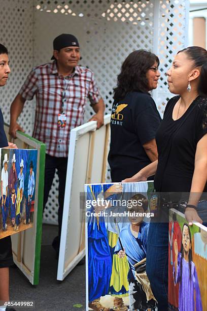 apache painter with family and paintings, santa fe indian market - american family fine art stock pictures, royalty-free photos & images