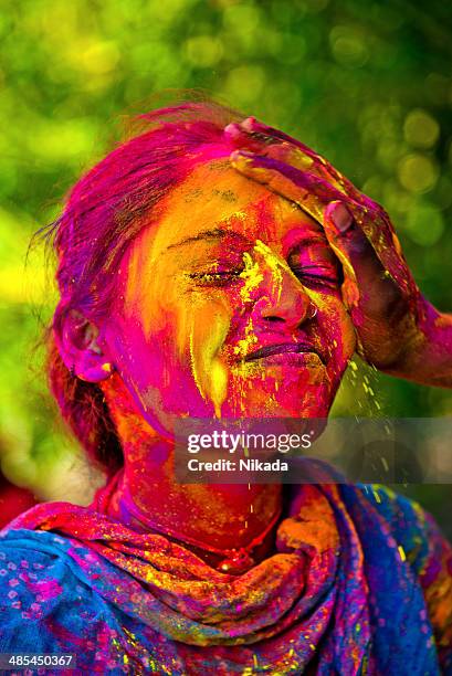 indian woman celebrating holi - holi portraits stock pictures, royalty-free photos & images