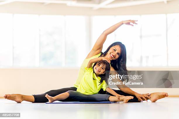 mother daughter yoga class - family yoga stock pictures, royalty-free photos & images