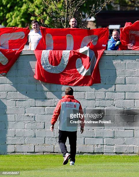 Brendan Rodgers manager of Liverpool speaks with fans who have displayed a banner with the message 'Make Us Dream' during a training session at...