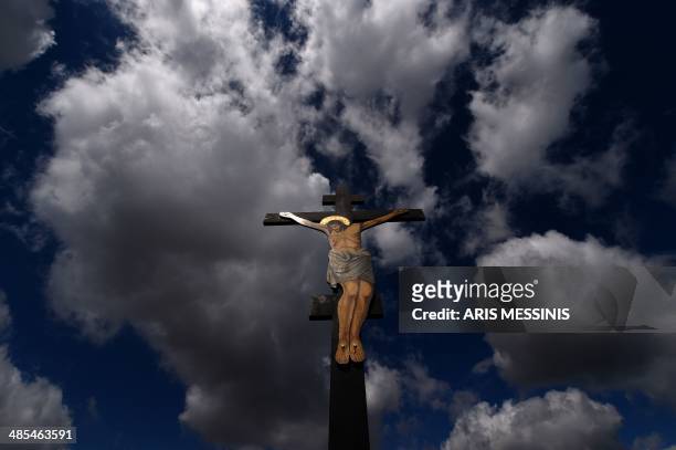 An image of Jesus crucified stands at a hill during the ceremony marking the Apokathelosis, the removal of Christ's body from the Cross, which forms...