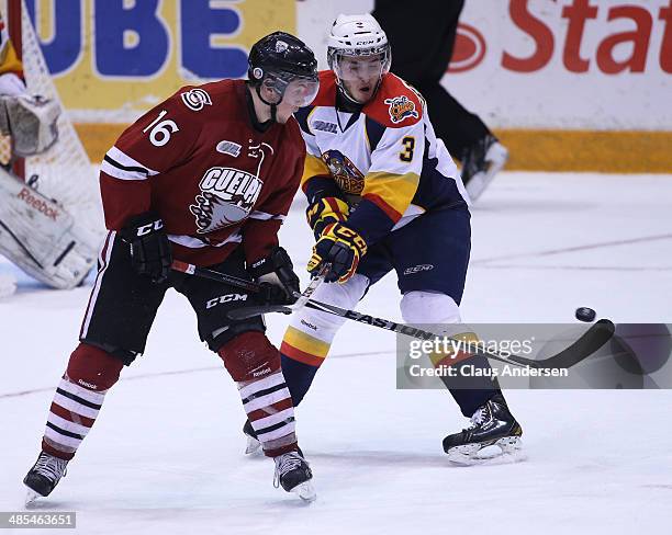 Cory Genovese of the Erie Otters tries to stop Kerby Rychel of the Guelph Storm from tipping a shot in Game One of the OHL Western Conference Final...