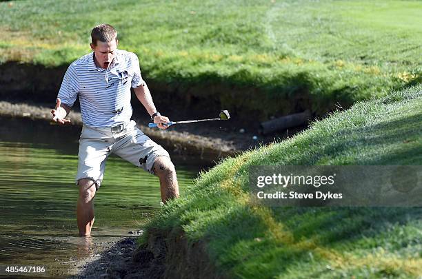 Peter Malnati reacts to his attempt to hit out of the edge of a pond on the 12th hole during the first round of the WinCo Foods Portland Open on...