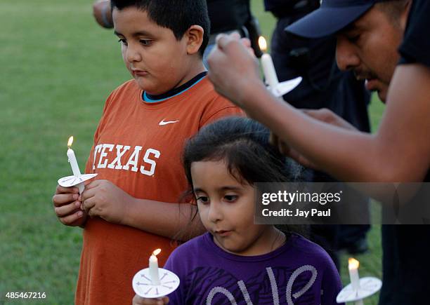 Residents hold candles during a vigil for Alison Parker on Martinsville High School's football field on August 27, 2015 in Martinsville, Virginia....