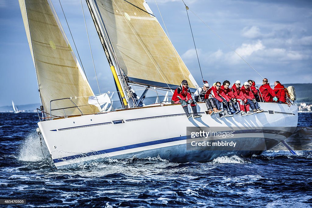 Sailing crew on sailboat during regatta