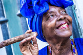 Portrait of african cuban woman smoking cigar in Havana, Cuba