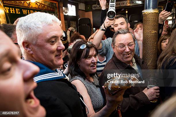 Woman arrives with the 2014 hot cross bun to be hung in a net above the bar of the Widow's Son pub in Bromley-by-Bow on April 18, 2014 in London,...