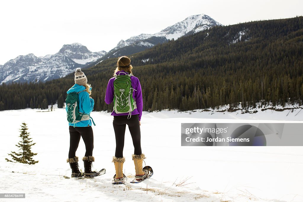 Two women showshoeing.