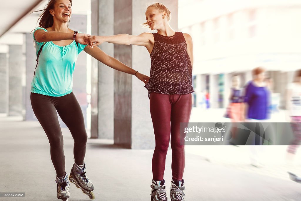 Girls bonding together and having fun with rollerskates