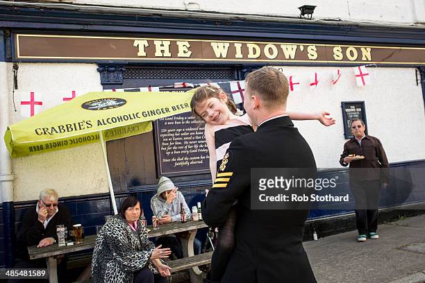 Eve Allen dances with her father Petty Officer Darbz Allen outside the Widow's Son pub in Bromley-by-Bow on April 18, 2014 in London, England. The...