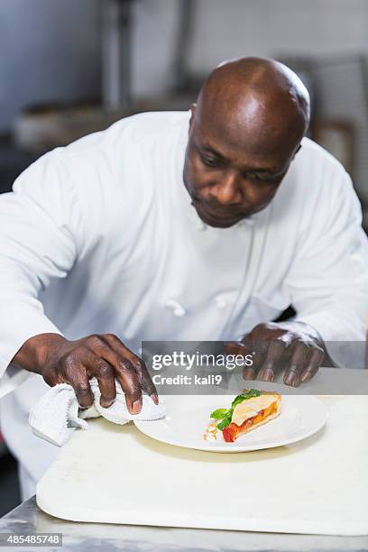 black chef in a restaurant plating food - dining presentation food stock pictures, royalty-free photos & images