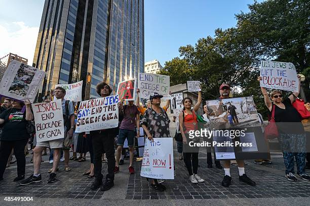 After marching from the American Museum of Natural History, demonstrators rally in Columbus Circle displaying their signs. Demonstrators rallied at...