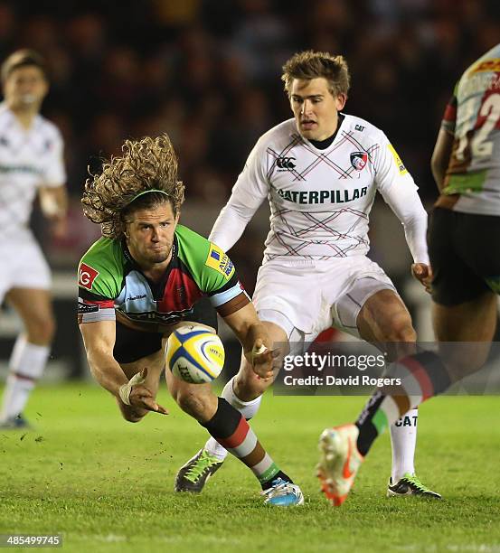 Luke Wallace of Harlequins passes the ball watched by Toby Flood during the Aviva Premiership match between Harlequins and Leicester Tigers at the...