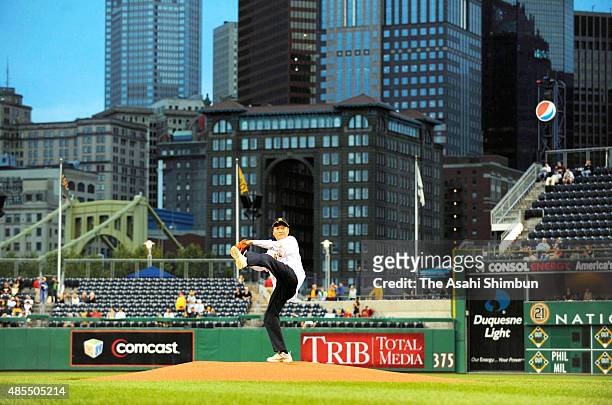 Japanese Prime Minister Yukio Hatoyama throws a memorial first pitch prior to the Pittsburgh Pirates and Los Angeles Dodgers on the sidelines of the...