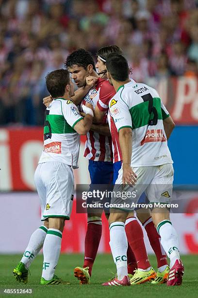 Diego Costa of Atletico de Madrid argues with Alberto Rivera of Elche FC and his team mate Alberto Tomas Botia during the La Liga match between Club...