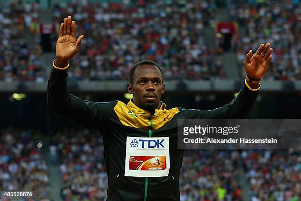 Gold medalist Usain Bolt of Jamaica poses on the podium during the medal ceremony for the Men's 200 metres final during day seven of the 15th IAAF...