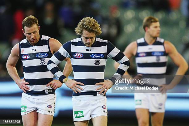 Steve Johnson of the Cats and Cameron Guthrie walk off after their defeat during the round 22 AFL match between the Geelong Cats and the Collingwood...