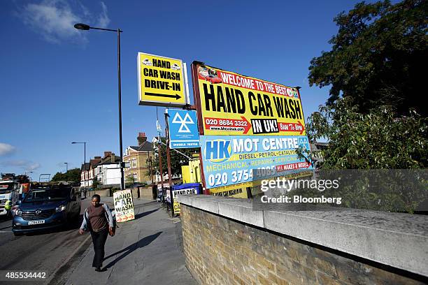 Signs advertise a hand car wash in the Thornton Heath neighbourhood of London, U.K., on Friday, Aug. 28, 2015. The fastest-rising neighborhood in...