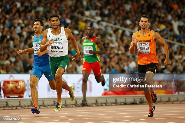 Oleksiy Kasyanov of Ukraine, Larbi Bourrada of Algeria and Eelco Sintnicolaas of the Netherlands cross the finish line in the Men's Decathlon 400...