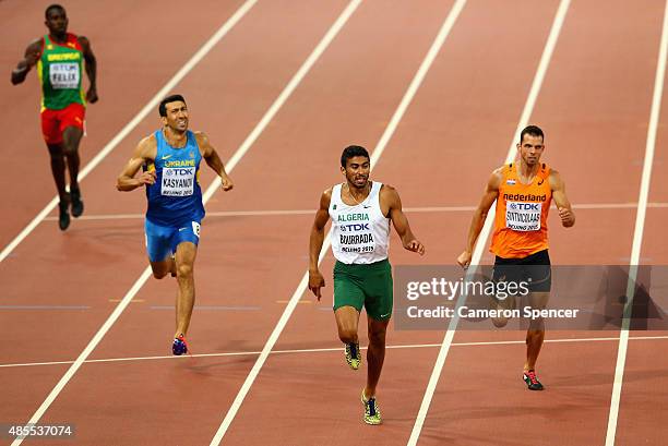 Oleksiy Kasyanov of Ukraine, Larbi Bourrada of Algeria and Eelco Sintnicolaas of the Netherlands cross the finish line in the Men's Decathlon 400...