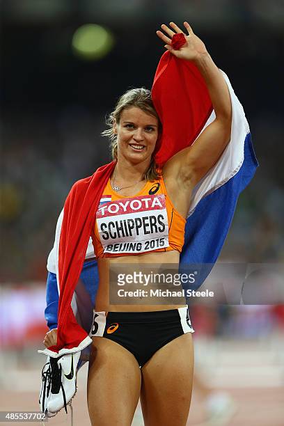 Dafne Schippers of the Netherlands celebrates after crossing the finish line to win gold in the Women's 200 metres final during day seven of the 15th...