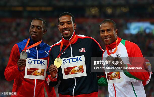 Silver medalist Pedro P. Pichardo of Cuba, gold medalist Christian Taylor of the United States and bronze medalist Nelson Evora of Portugal pose on...