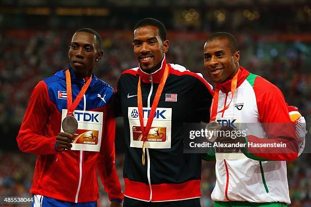 Silver medalist Pedro P. Pichardo of Cuba, gold medalist Christian Taylor of the United States and bronze medalist Nelson Evora of Portugal pose on...