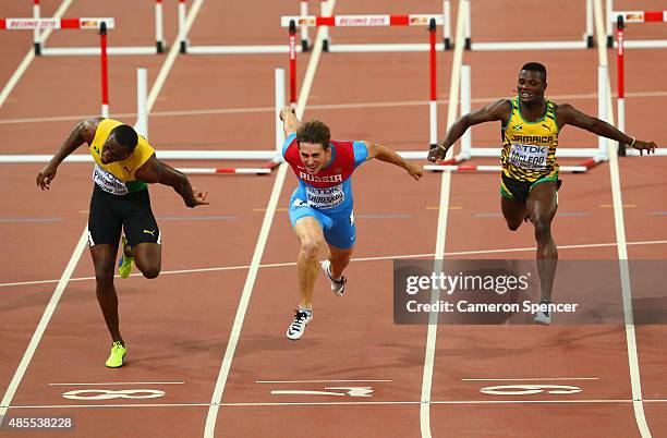 Sergey Shubenkov of Russia crosses the finish line to win gold in the Men's 110 metres hurdles final ahead of Hansle Parchment of Jamaica during day...