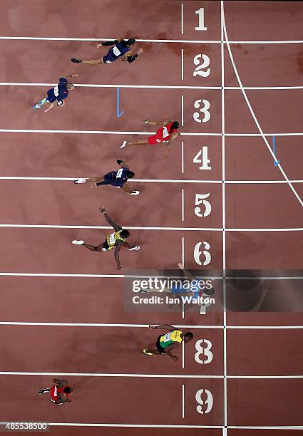 Sergey Shubenkov of Russia crosses the finish line to win gold in the Men's 110 metres hurdles final ahead of Hansle Parchment of Jamaica during day...