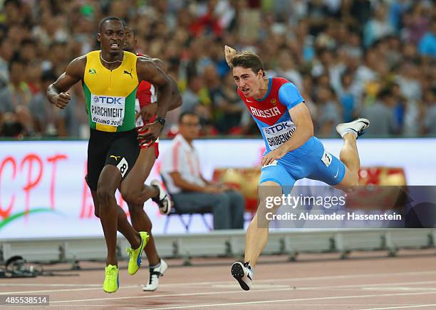 Sergey Shubenkov of Russia crosses the finish line to win gold in the Men's 110 metres hurdles final ahead of Hansle Parchment of Jamaica during day...