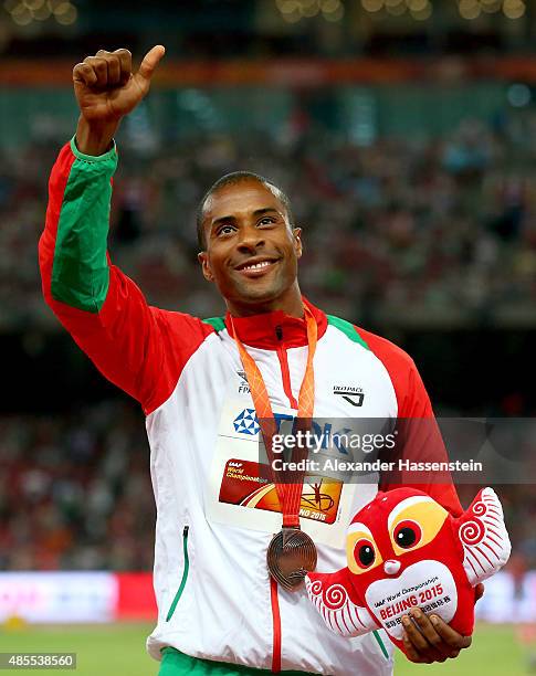Bronze medalist Nelson Evora of Portugal poses on the podium during the medal ceremony for the Men's Triple Jump final during day seven of the 15th...