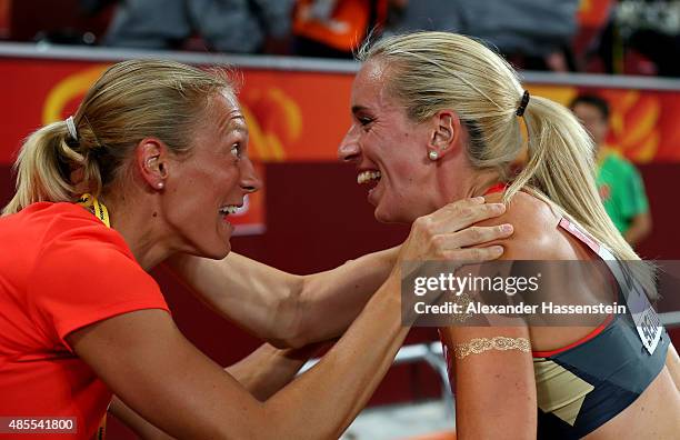 Cindy Roleder of Germany celebrates with Jennifer Oeser of Germany after winning silver in the Women's 100 metres hurdles final during day seven of...