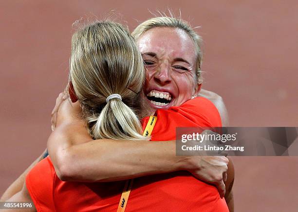 Cindy Roleder of Germany celebrates with Jennifer Oeser of Germany after winning silver in the Women's 100 metres hurdles final during day seven of...