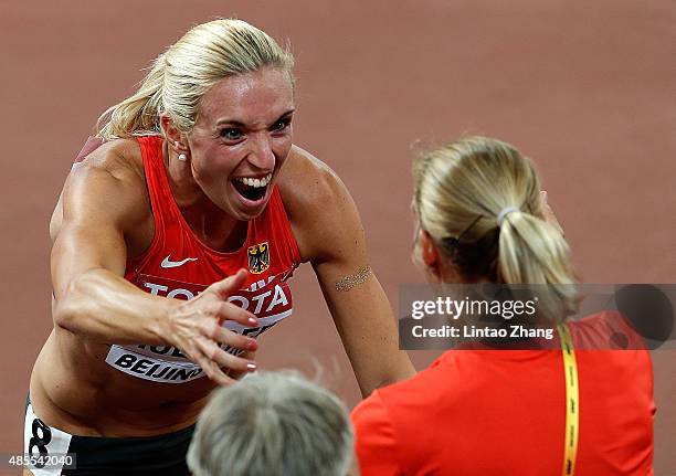 Cindy Roleder of Germany celebrates with Jennifer Oeser of Germany after winning silver in the Women's 100 metres hurdles final during day seven of...