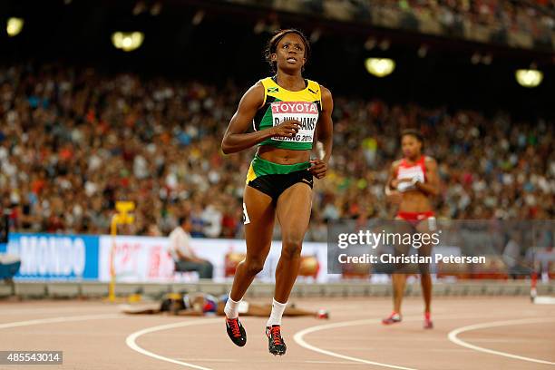 Danielle Williams of Jamaica celebrates after crossing the finish line to win gold in the Women's 100 metres hurdles final during day seven of the...