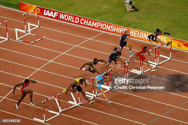 Sergey Shubenkov of Russia crosses the finish line to win gold in the Men's 110 metres hurdles final ahead of Hansle Parchment of Jamaica during day...