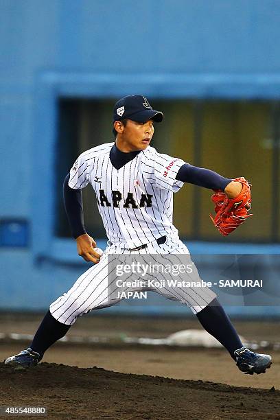 Starting pitcher Shotaro Ueno of Japan pitches in the top half of the first inning in the first round game between Japan and Brazil during the 2015...