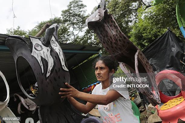 By Blanca Morel Thirty-eight-year-old Josefa Salazar, hangs bird figurines made of discarded tyres at a shop in Masaya, a city along the Pan-American...