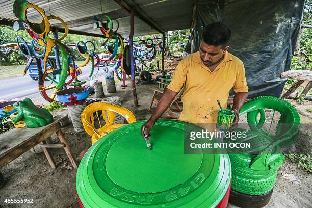 By Blanca Morel Forty-year-old Francisco Moreno, paints a table made out of discarded tyres at a shop in Masaya, a city along the Pan-American...