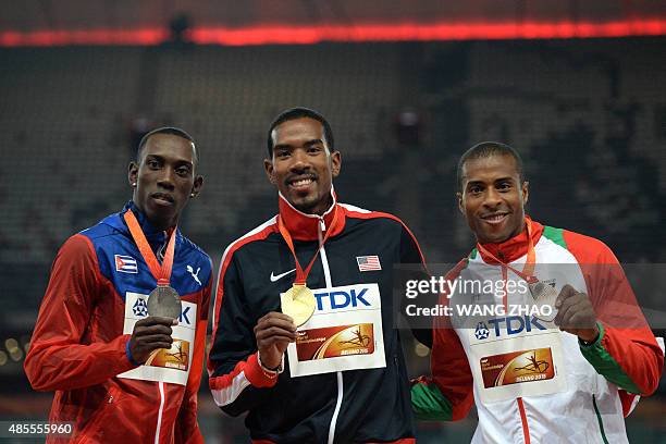 Cuba's silver medallist Pedro P. Pichardo, USA's gold medallist Christian Taylor and Portugal's bronze medallist Nelson Evora poses on the podium...