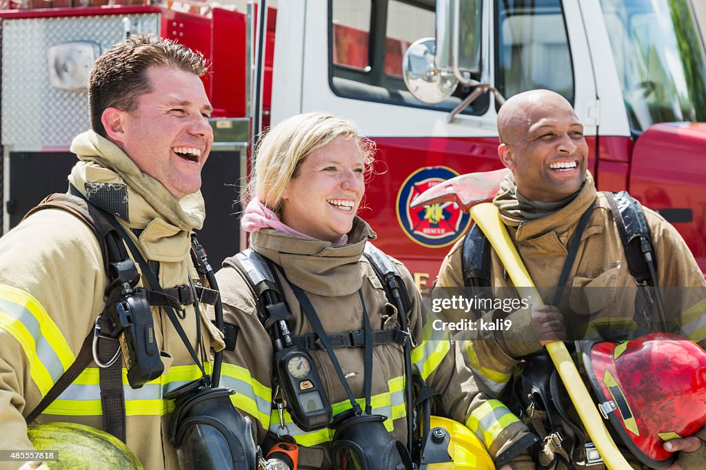 Firefighters in protective gear with fire rescue trucks