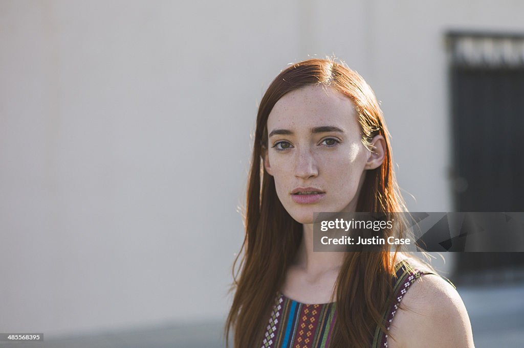 Portrait of a red haired woman in the sun