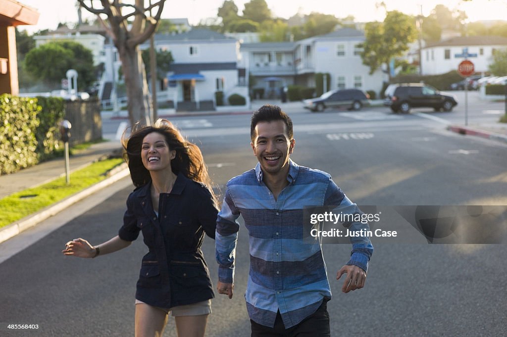 Couple running joyfully in the street
