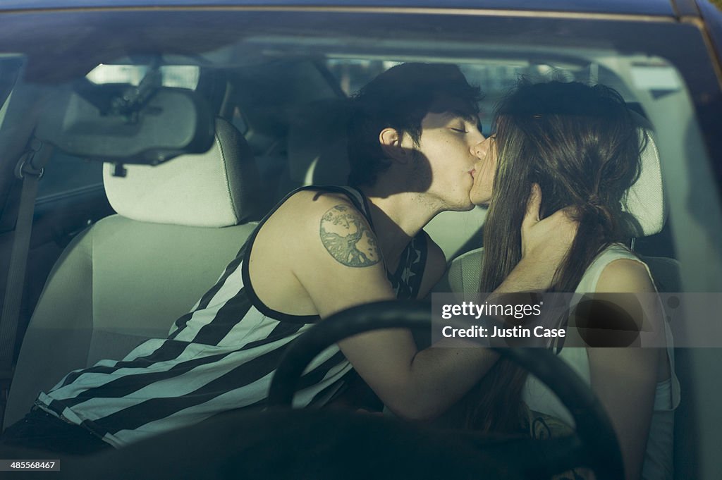 Couple kissing inside a car