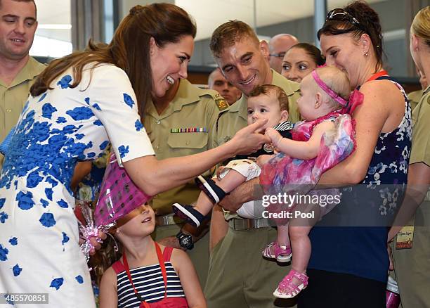 Catherine, Duchess of Cambridge says hello to six-month-old Alyssa McCabe, held by her mother Jillian as she meets with families of service personnel...