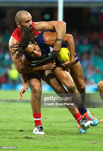 Tendai Mzungu of the Dockers is tackled by Rhyce Shaw of the Swans during the round five AFL match between the Sydney Swans and the Fremantle Dockers...