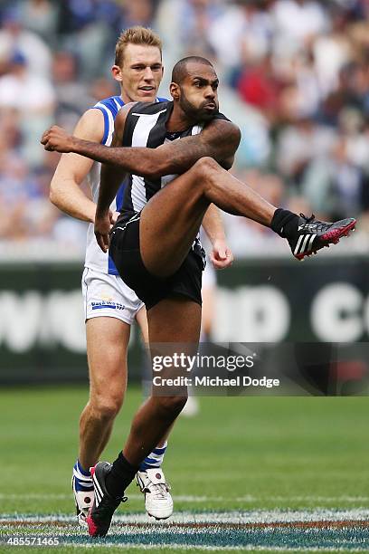 Heritier O'Brien of the Magpies kicks the ball during the round five AFL match between the Collingwood Magpies and the North Melbourne Kangaroos at...