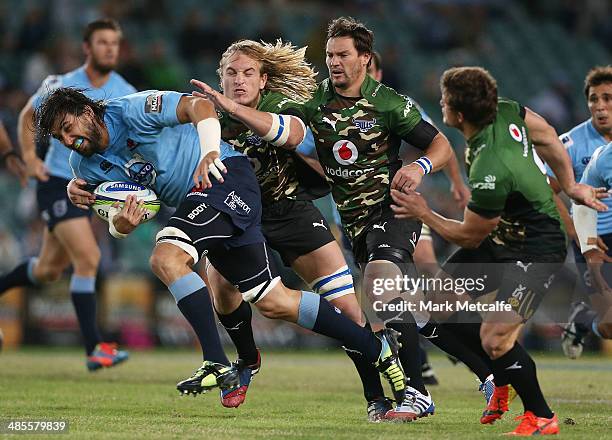 Jacques Potgieter of the Waratahs is tackled during the round 10 Super Rugby match between the Waratahs and the Bulls at Allianz Stadium on April 19,...